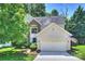 Charming two-story home featuring an attached garage and well-manicured landscaping, flag out front at 7833 Taymouth Ln, Charlotte, NC 28269