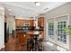 Cozy kitchen with wood cabinets, stainless appliances, and dining table with seating at 7833 Taymouth Ln, Charlotte, NC 28269