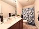 Bathroom featuring a vanity with sink and a shower with a blue floral curtain at 815 Fescue Ct, Charlotte, NC 28216