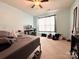 Bedroom featuring a bed and a window with curtains and a ceiling fan at 815 Fescue Ct, Charlotte, NC 28216