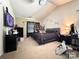 A spacious bedroom with a gray bed, beige carpet, and vaulted ceilings at 815 Fescue Ct, Charlotte, NC 28216