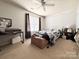 Bedroom featuring a window and bed with brown curtains and a ceiling fan at 815 Fescue Ct, Charlotte, NC 28216