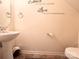Half bathroom with a sleek pedestal sink and neutral wall decor at 815 Fescue Ct, Charlotte, NC 28216