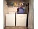 Functional laundry area with appliances and shelving for storage and organization at 815 Fescue Ct, Charlotte, NC 28216