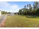 Large grass backyard with fenced perimeter and utility shed provides a serene atmosphere at 975 Mt Moriah Church Rd, China Grove, NC 28023