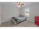 Cozy bedroom with a full-sized bed, ceiling fan, and a view from the window at 975 Mt Moriah Church Rd, China Grove, NC 28023