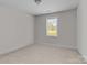 Neutral bedroom with beige carpet and gray walls is brightly lit by a window at 975 Mt Moriah Church Rd, China Grove, NC 28023