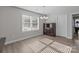 Bright dining room features light-colored walls, wood floors, a wooden cabinet, and a window with sunlight streaming in at 975 Mt Moriah Church Rd, China Grove, NC 28023