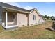 Exterior view of a home with light siding, a small porch, and a fenced backyard at 975 Mt Moriah Church Rd, China Grove, NC 28023