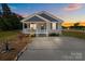 Charming single story home with a welcoming front porch and well-kept yard at sunset at 975 Mt Moriah Church Rd, China Grove, NC 28023