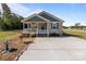Charming single-story home with a covered porch and a well-maintained front yard with ornamental rocks and concrete driveway at 975 Mt Moriah Church Rd, China Grove, NC 28023