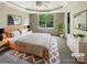 Stylish main bedroom with tray ceilings, a ceiling fan, a window, and a walk in closet at 10406 Baskerville Ave, Charlotte, NC 28269