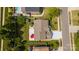 An aerial view shows a well-maintained property featuring a spacious backyard with mature trees and a vibrant red umbrella at 10815 Mountain Springs Dr, Charlotte, NC 28278