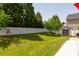 The backyard is spacious with mature trees and a pristine white fence at 10815 Mountain Springs Dr, Charlotte, NC 28278