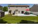 Home's backyard features a spacious grassy area, patio, and outdoor grill, perfect for entertaining at 10815 Mountain Springs Dr, Charlotte, NC 28278