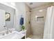 Updated bathroom features a tiled shower with a decorative inlay and a marble vanity top at 10815 Mountain Springs Dr, Charlotte, NC 28278