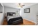 Cozy bedroom featuring hardwood floors, a ceiling fan, natural light, and modern finishes at 10815 Mountain Springs Dr, Charlotte, NC 28278