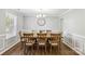 Elegant dining room featuring a wooden table set for eight, with stylish decor and natural light at 10815 Mountain Springs Dr, Charlotte, NC 28278