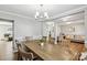 Open concept dining room with wood floors and views into the living area, perfect for entertaining at 10815 Mountain Springs Dr, Charlotte, NC 28278
