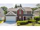 Charming two-story home with red shutters, brick accents, and a well-manicured front lawn at 10815 Mountain Springs Dr, Charlotte, NC 28278
