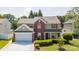 Charming two-story home with red shutters, brick accents, and a well-manicured front lawn at 10815 Mountain Springs Dr, Charlotte, NC 28278