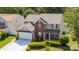 Inviting two-story home featuring a two-car garage, manicured lawn, and traditional architectural details at 10815 Mountain Springs Dr, Charlotte, NC 28278
