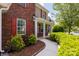 Close-up view of the home's brick facade, front porch, and neatly landscaped walkway at 10815 Mountain Springs Dr, Charlotte, NC 28278