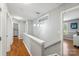 Bright upstairs hallway with hardwood floors and natural light leads to bedrooms and other living spaces at 10815 Mountain Springs Dr, Charlotte, NC 28278