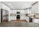 Well-lit kitchen with white cabinetry, stainless steel appliances, and granite countertops at 10815 Mountain Springs Dr, Charlotte, NC 28278