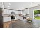 Modern kitchen with white cabinets, stainless steel appliances, granite countertops and wooden center island at 10815 Mountain Springs Dr, Charlotte, NC 28278