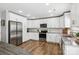 Bright kitchen featuring white cabinets, stainless steel appliances, granite countertops, and a center island at 10815 Mountain Springs Dr, Charlotte, NC 28278