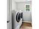 Bright laundry area features modern, front-load washer and dryer at 10815 Mountain Springs Dr, Charlotte, NC 28278