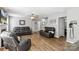 Spacious living room with grey walls, wood floors, ceiling fan, and leather furniture at 10815 Mountain Springs Dr, Charlotte, NC 28278