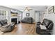 This cozy living room features a fireplace, leather furniture, and a ceiling fan at 10815 Mountain Springs Dr, Charlotte, NC 28278