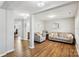 Inviting living room features hardwood floors, grey sofa set, and subtle decor, with a view into the office at 10815 Mountain Springs Dr, Charlotte, NC 28278