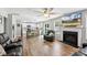 Open-concept living room flows into the kitchen, complete with a fireplace and view of the backyard at 10815 Mountain Springs Dr, Charlotte, NC 28278
