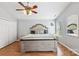 Comfortable main bedroom with ceiling fan, vaulted ceiling, a large bed, and two windows with natural light at 10815 Mountain Springs Dr, Charlotte, NC 28278