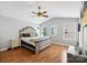 Spacious main bedroom featuring a vaulted ceiling, ceiling fan, and ample natural light from multiple windows at 10815 Mountain Springs Dr, Charlotte, NC 28278