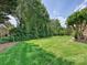 Expansive backyard with lush green grass, surrounded by mature trees and manicured hedges at 11321 James Jack Ln, Charlotte, NC 28277