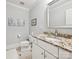 Well-lit bathroom featuring a granite countertop, white cabinets, and classic fixtures at 11321 James Jack Ln, Charlotte, NC 28277