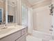 Clean bathroom with a white vanity, a shower and tub combination, and natural light from the window at 11321 James Jack Ln, Charlotte, NC 28277