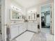 Elegant bathroom with dual vanities, marble countertops, and access to a walk-in closet at 11321 James Jack Ln, Charlotte, NC 28277