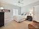 Inviting bedroom with neutral decor, a ceiling fan, and ample natural light from the window at 11321 James Jack Ln, Charlotte, NC 28277