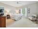 Serene bedroom with a walk-in closet, a cushioned chair, and large windows for natural light at 11321 James Jack Ln, Charlotte, NC 28277