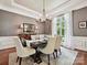 Formal dining room featuring elegant decor, chandelier, and a large window with sheer curtains at 11321 James Jack Ln, Charlotte, NC 28277
