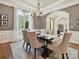 Elegant dining room with a chandelier, hardwood floors and a large window with sheer curtains at 11321 James Jack Ln, Charlotte, NC 28277
