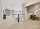 Bright hallway with a white railing, leading to an open living space with comfortable seating at 11321 James Jack Ln, Charlotte, NC 28277