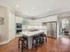 Bright kitchen with a spacious island, stainless steel appliances and a hardwood floor at 11321 James Jack Ln, Charlotte, NC 28277