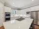 Bright kitchen with stainless appliances, white cabinets, granite countertops and a center island with cooktop at 11321 James Jack Ln, Charlotte, NC 28277