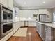 A chef's kitchen featuring white cabinets, stainless appliances, and a center island with a gas cooktop at 11321 James Jack Ln, Charlotte, NC 28277